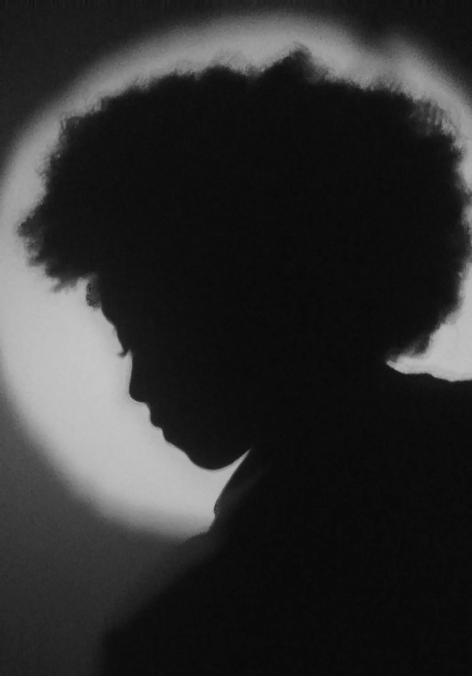 A person standing in front of the spotlight.